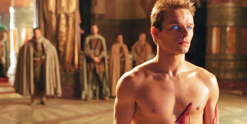 A man standing with a cut on his body and blue eyes in Dune 2000