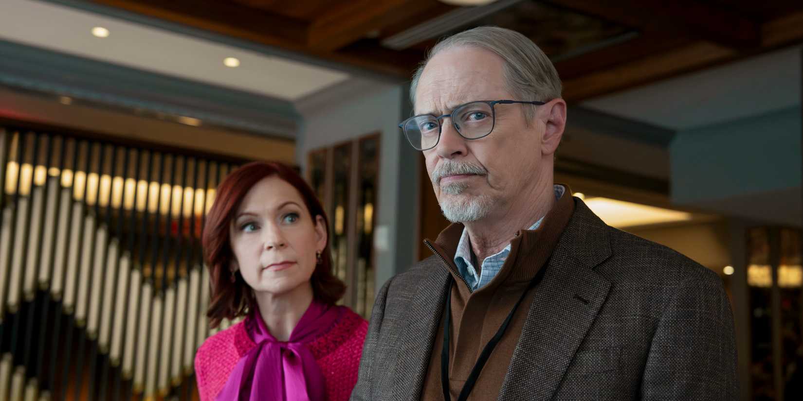 Steve Buscemi glancing with curiosity alongside Carrie Preston in Elsbeth