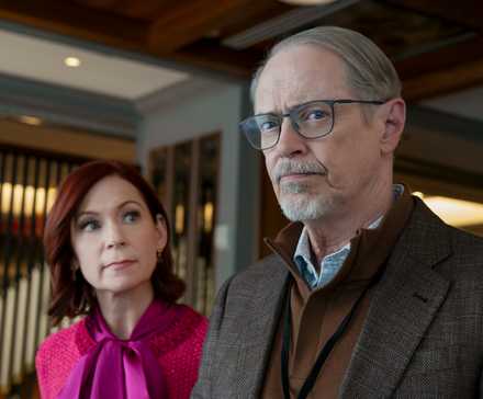 Steve Buscemi glancing with curiosity alongside Carrie Preston in Elsbeth