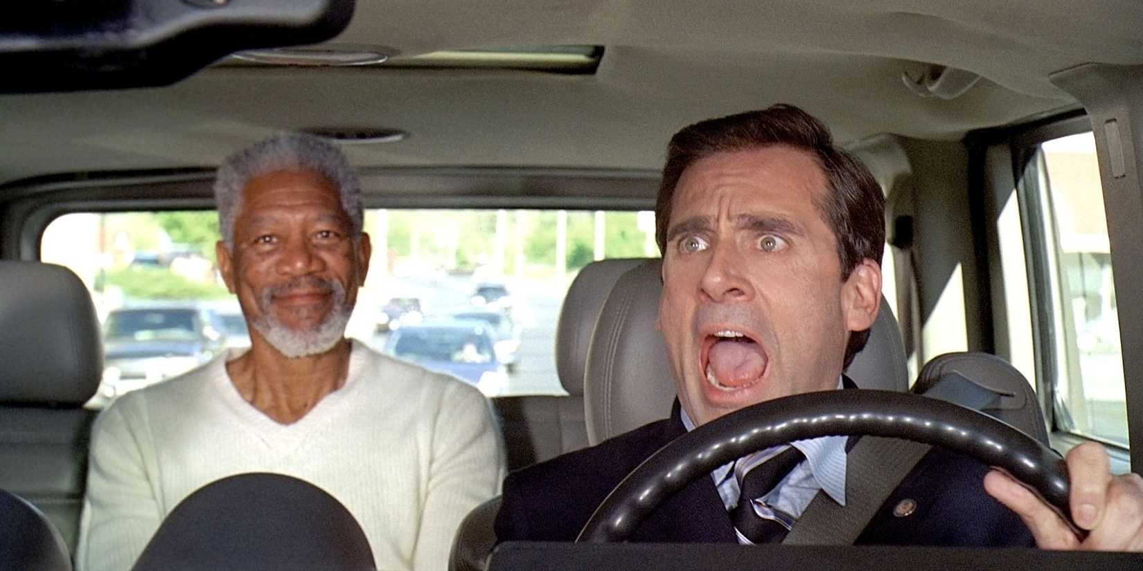 Morgan Freeman sits in the back of a car with Steve Carell screaming in shock as the driver in Evan Almighty