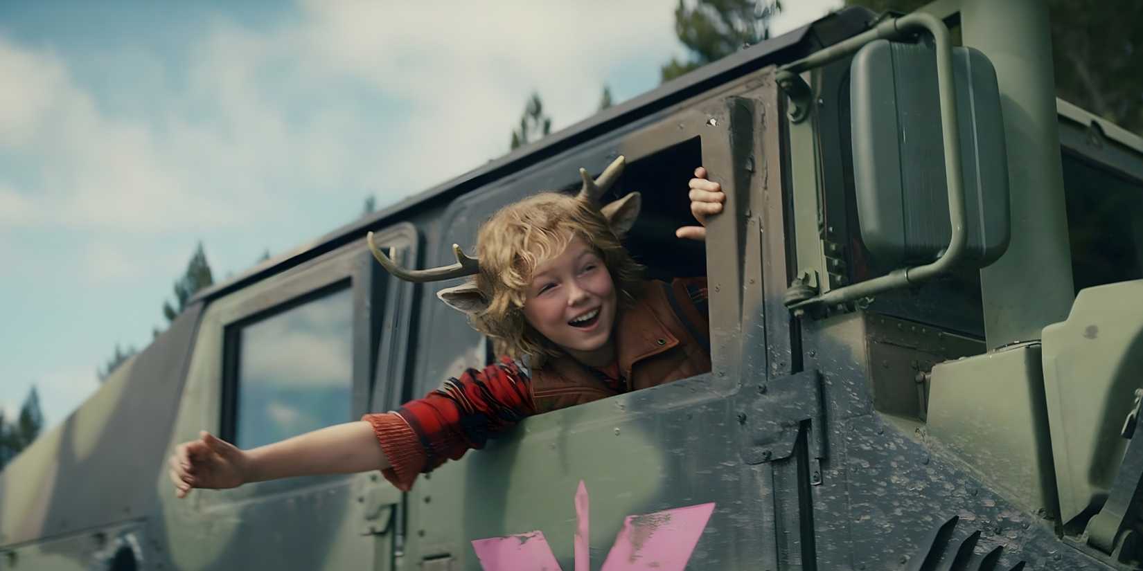 Gus (Christian Convery) smiles widely with his head out the jeep window in Sweet Tooth.
