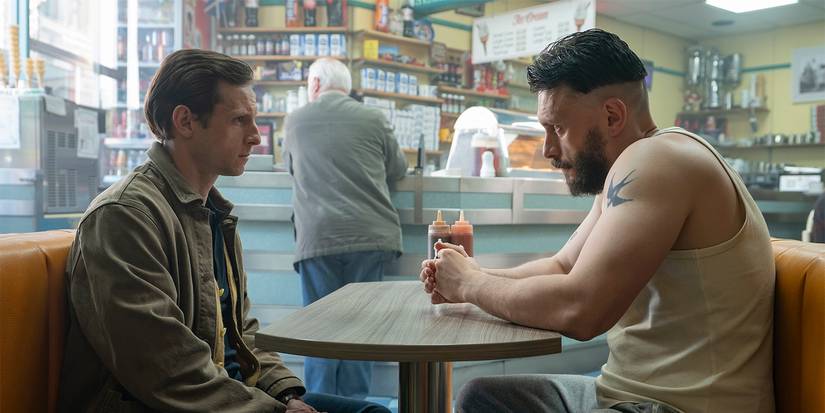 Two men sitting across from one another in a diner in Half Man.
