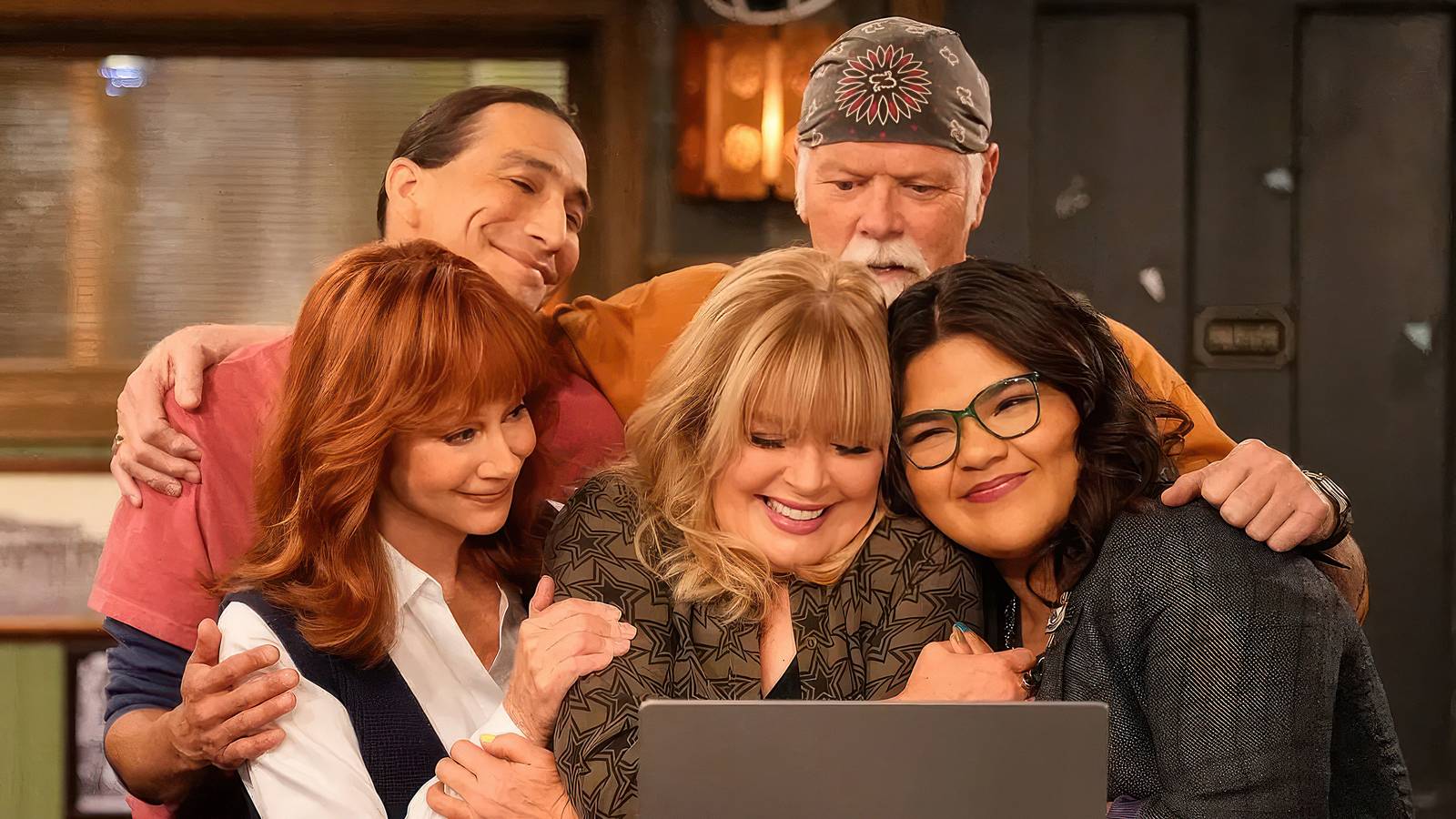 The cast of Happy's Place celebrate with a group hug