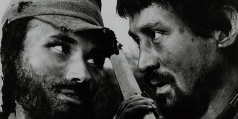 Two men standing close to each other looking at each other in Fires on the Plain - 1959