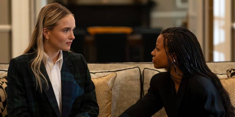 Miriam Petche as Sweetpea sitting on the couch looking at Myha'la as Harper in Industry Season 4