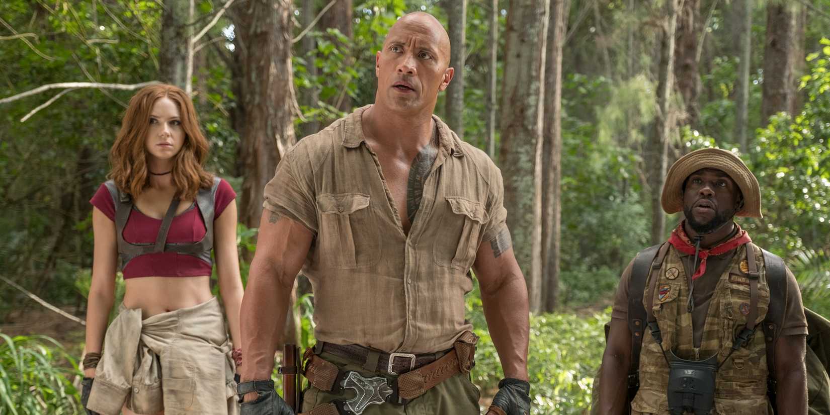 Dwayne Johnson, Karen Gillan, and Kevin Hart staring up at something in Jumanji: Welcome to the Jungle