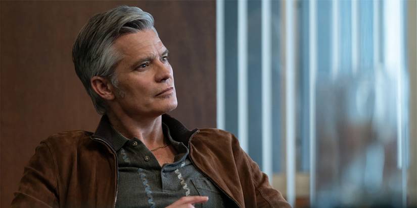 Timothy Olyphant sitting back in a chair in Lucky.