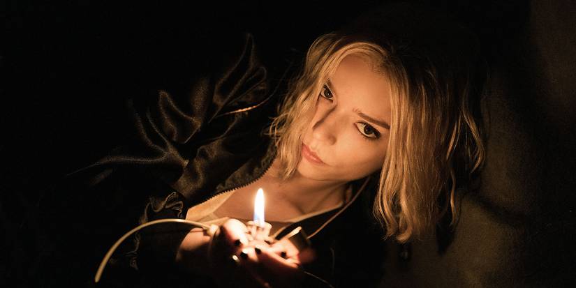 Anya Taylor-Joy in the dark lighting a match in Lucky.