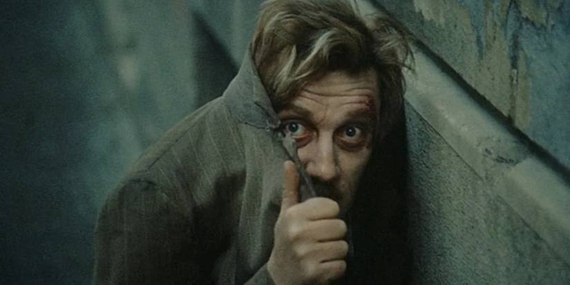 Man covering his face with coat in 'The Fifth Seal'