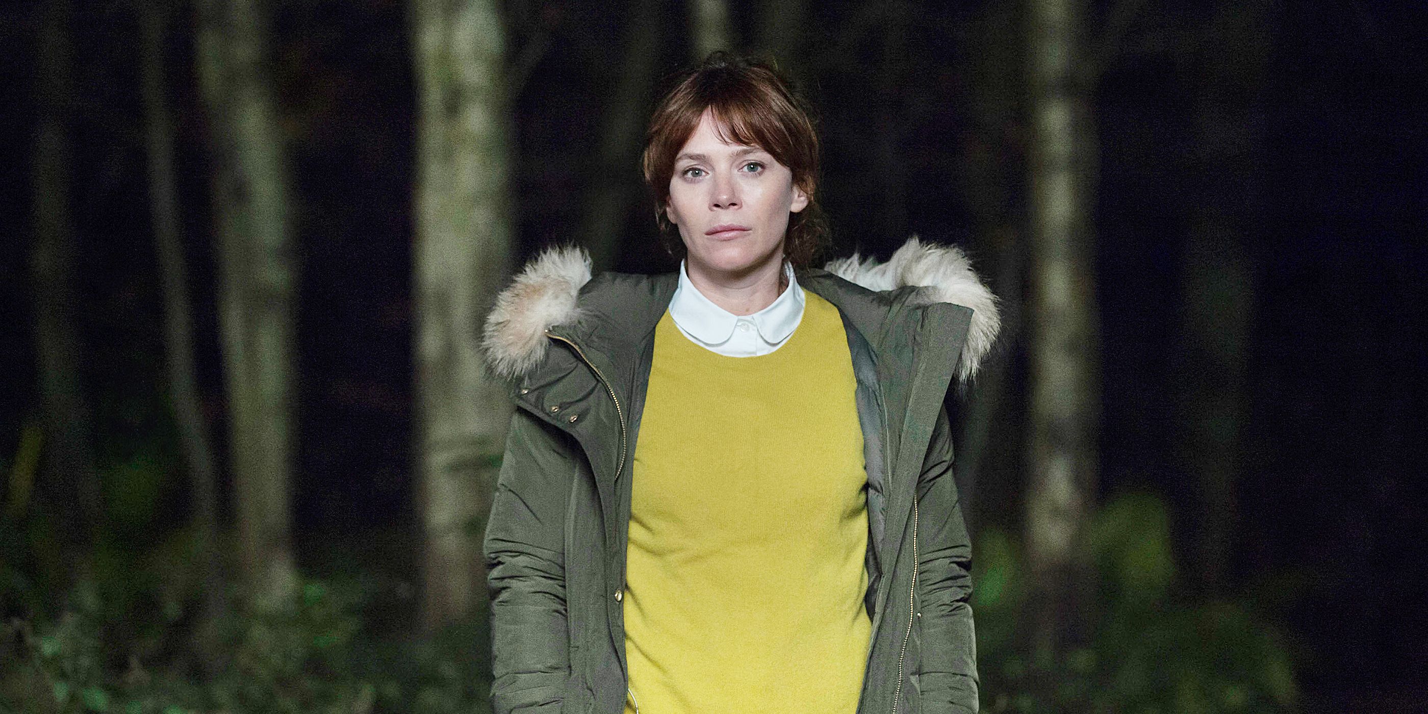 Anna Friel staring ahead in the woods in Marcella.
