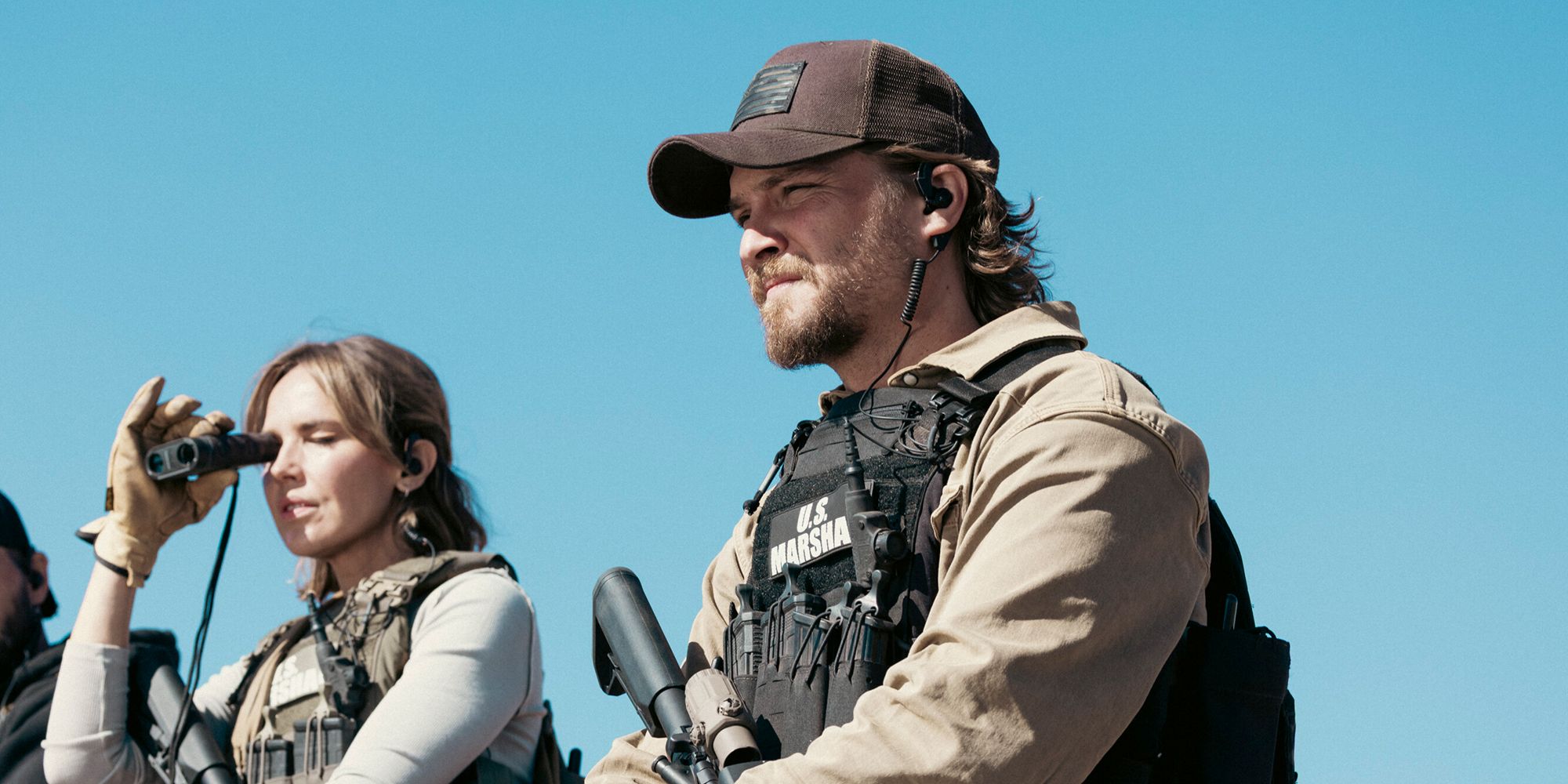 Luke Grimes as Kayce Dutton in his gear watching something from afar in Marshals Season 1