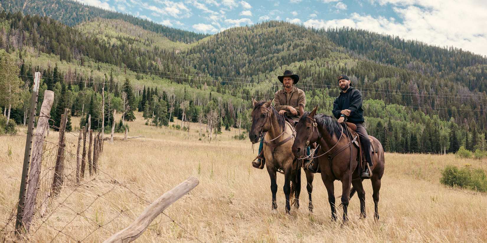 Luke Grimes as Kayce Dutton next to Logan Marshall-Green as Pete Calvin on horses in Marshals Season 1
