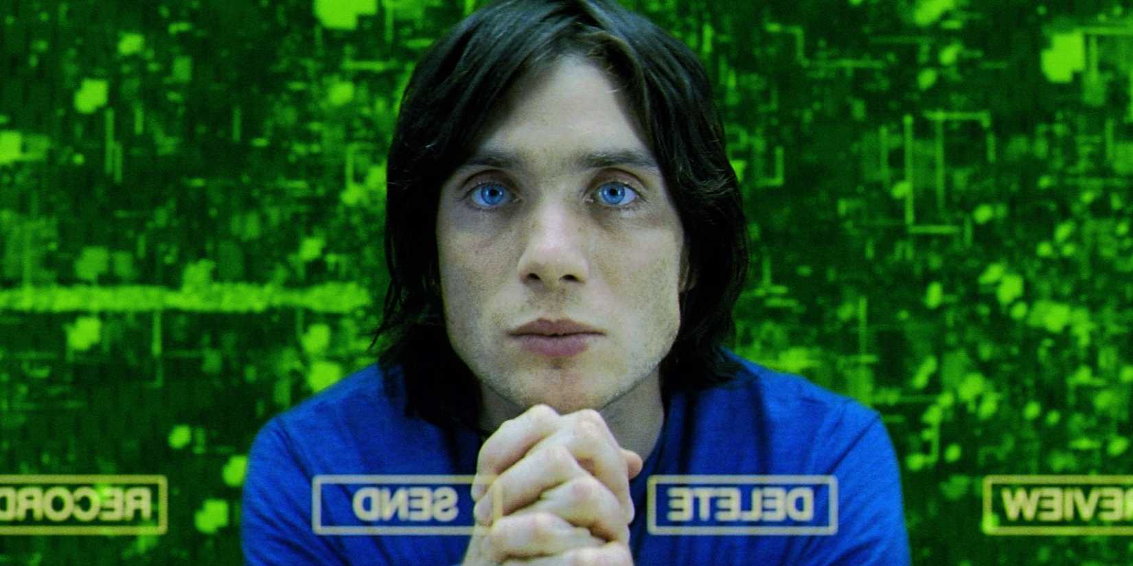 Cillian Murphy stares into the monitor, surrounded by green computer graphics, in Sunshine