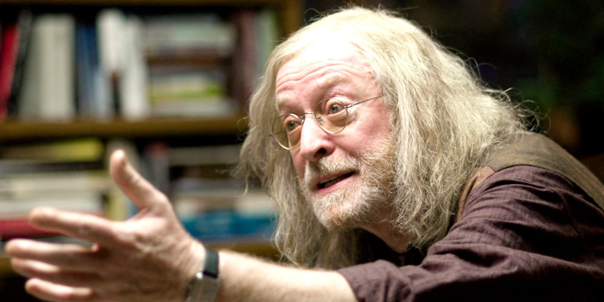 Jasper gesturing with an earnest expression in Children of Men