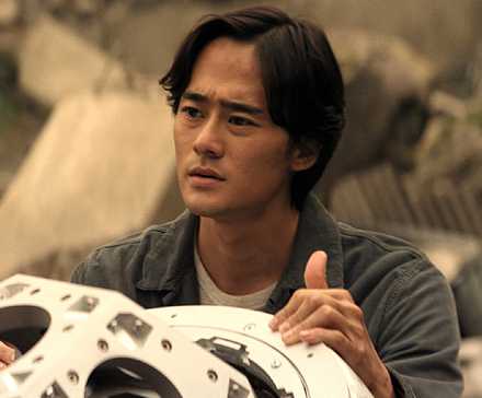 Ren Watabe holding a machine in 'Monarch: Legacy of Monsters'