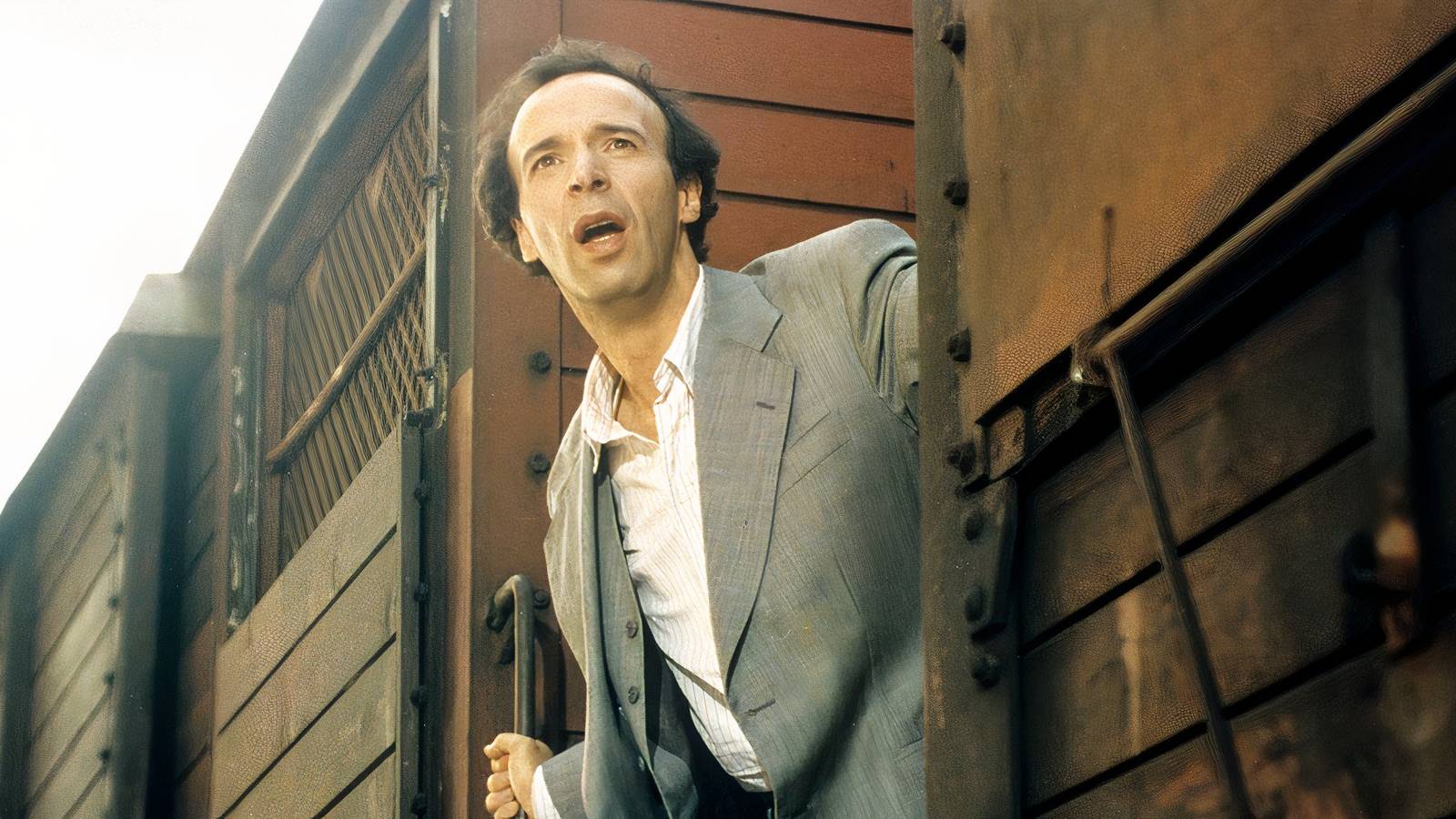 Roberto Benigni leans out of a train in Life is Beautiful