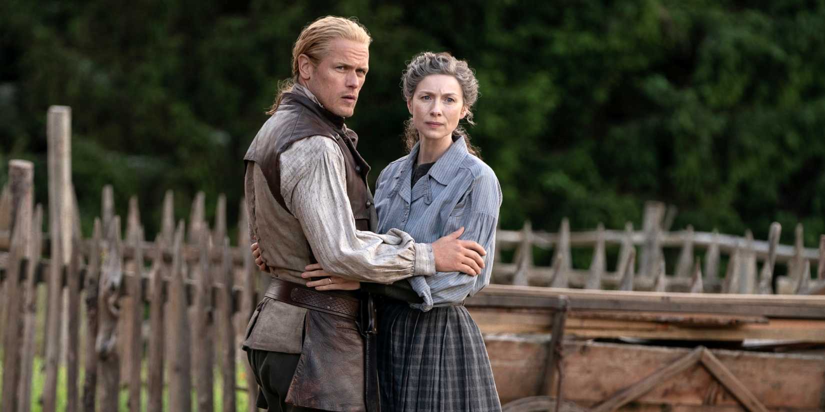 Caitriona Balfe as Claire with Sam Heughan as Jamie holding each other at the waist in Outlander Season 8