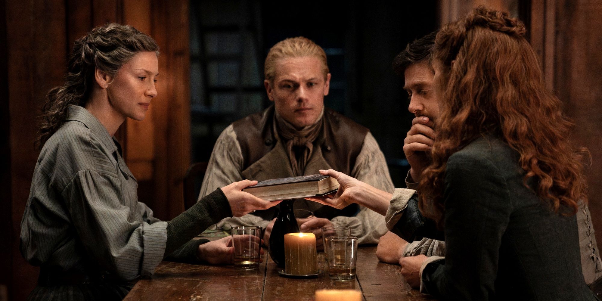 Sam Heughan sitting with Caitriona Balfe, Richard Rankin and Sophie Skelton in Outlander Season 8