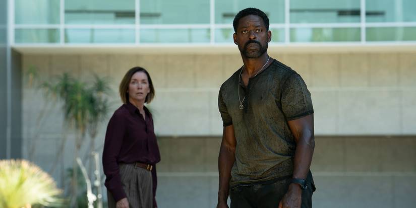 Xavier standing in front of Sam as they both look at something in horror in Paradise.