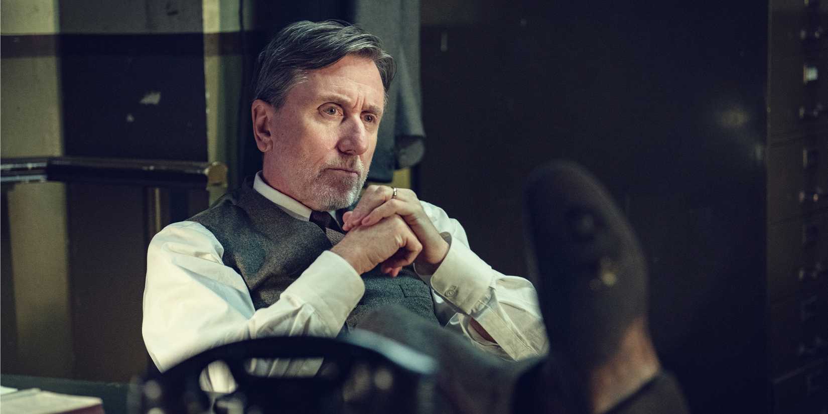 John Beckett sits at a desk with his feet up.