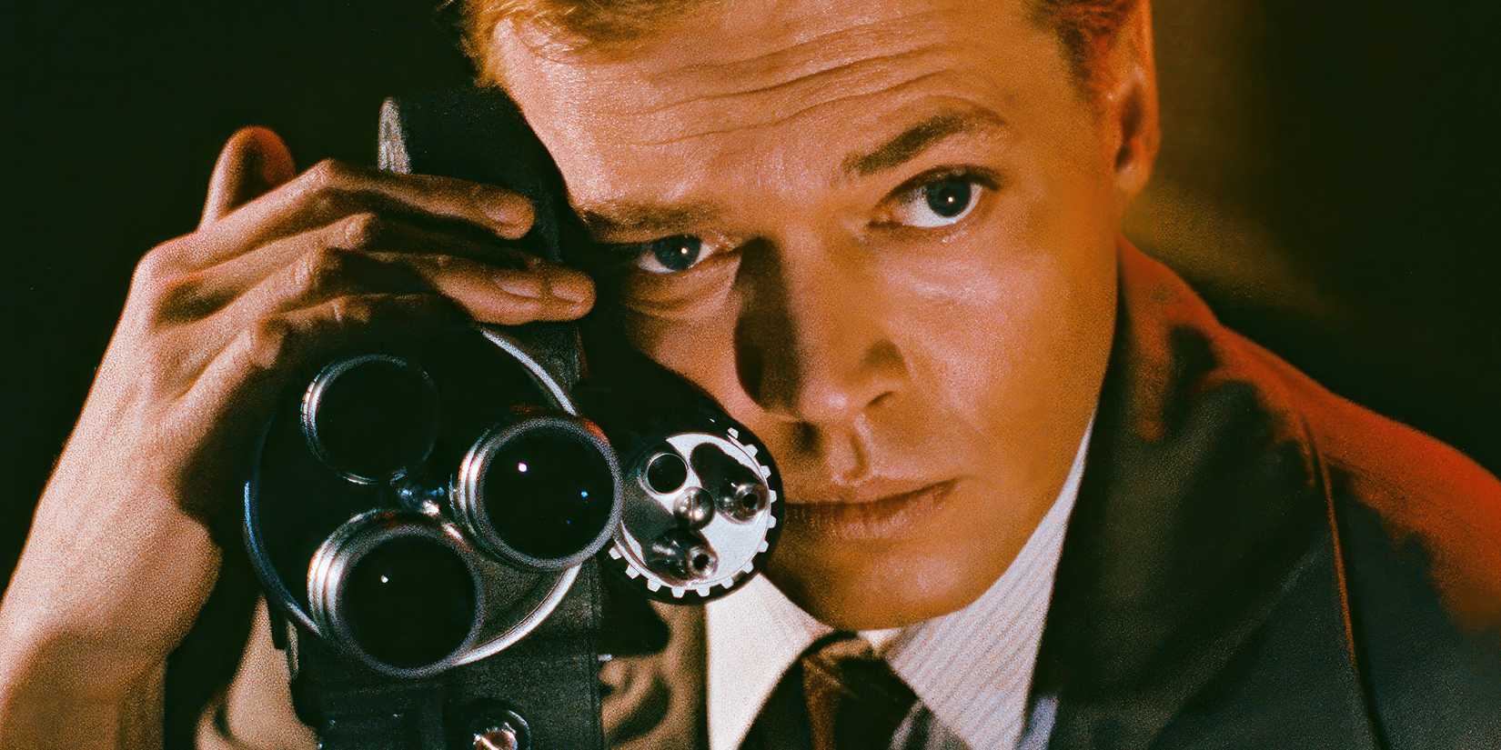 A man holding on to a camera in Peeping Tom