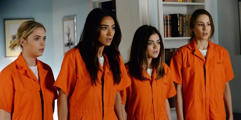 Ashley Benson, Troian Bellisario, Shay Mitchell and Lucy Hale in orange jumpsuits in Pretty Little Liars.