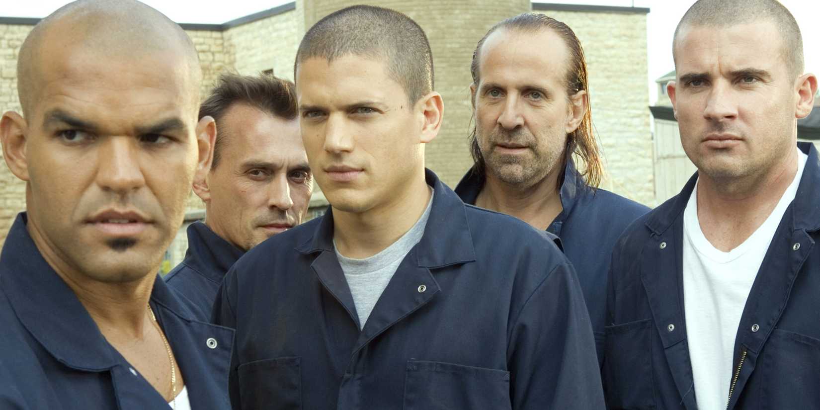Wentworth Miller, Dominic Purcell, and others lineup in jumpsuits in Prison Break image