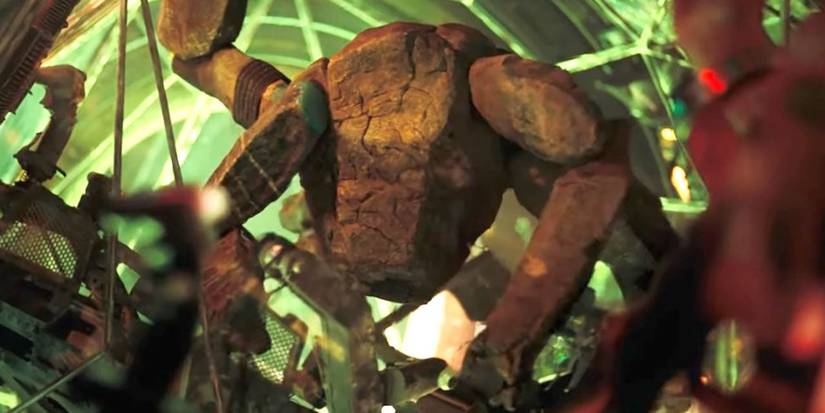 An alien being made of rocks with five limbs and an elongated core against a green background