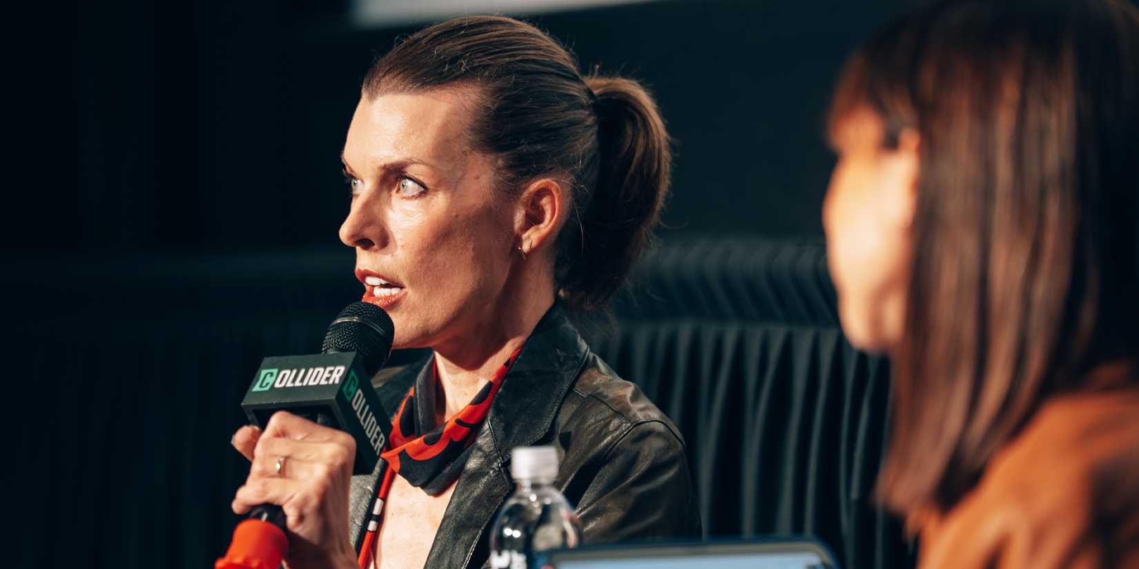 Milla Jovovich speaks on stage for Collider's Protector Q&A.