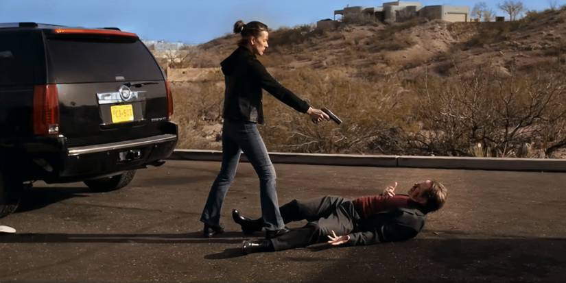 Milla Jovovich drawing her gun on some dude who's about to have a very bad time in Protector.