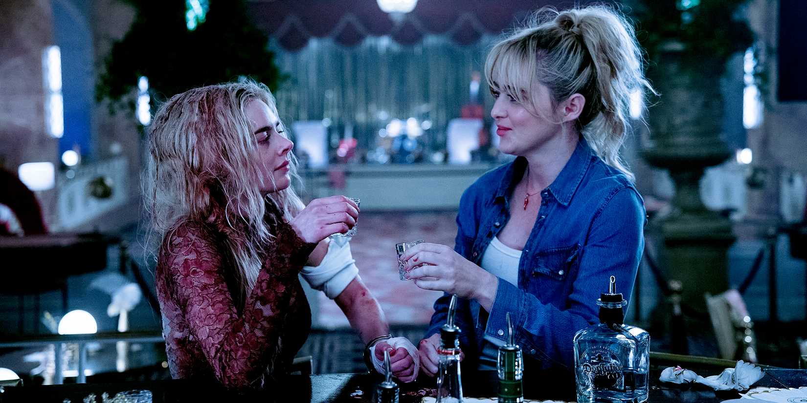 Faith and Grace toast to each other with shots.