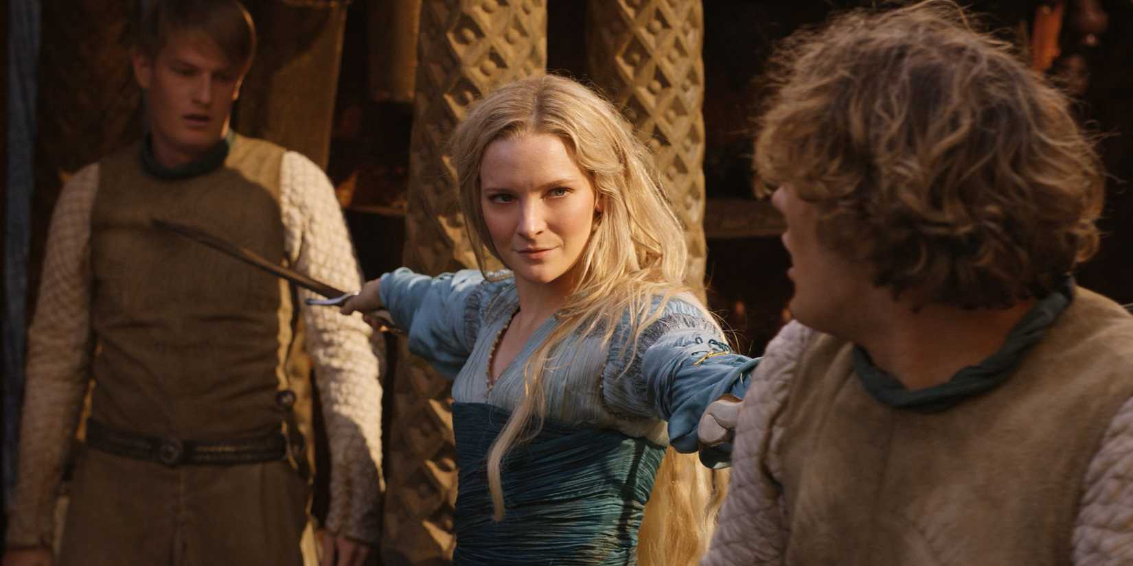 Galadriel holds two swords at human soldiers