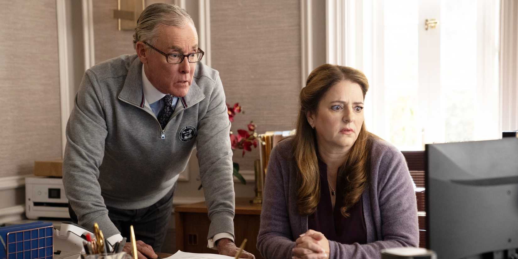 Walter and Cristle looking at something on a computer screen in horror.