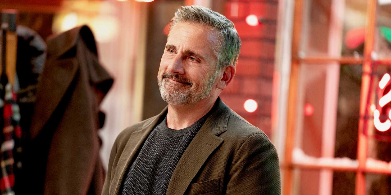 An author (Steve Carell) smiles proudly. 