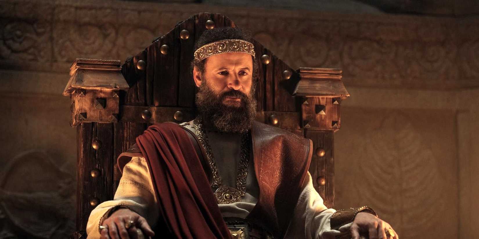 Ali Suliman as King Saul sitting on the throne in House of David Season 2