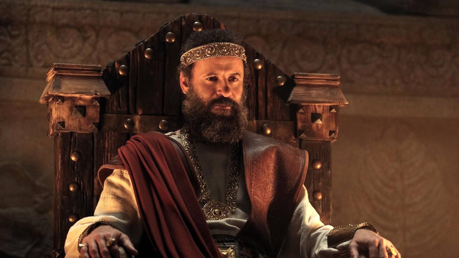 Ali Suliman as King Saul sitting on the throne in House of David Season 2