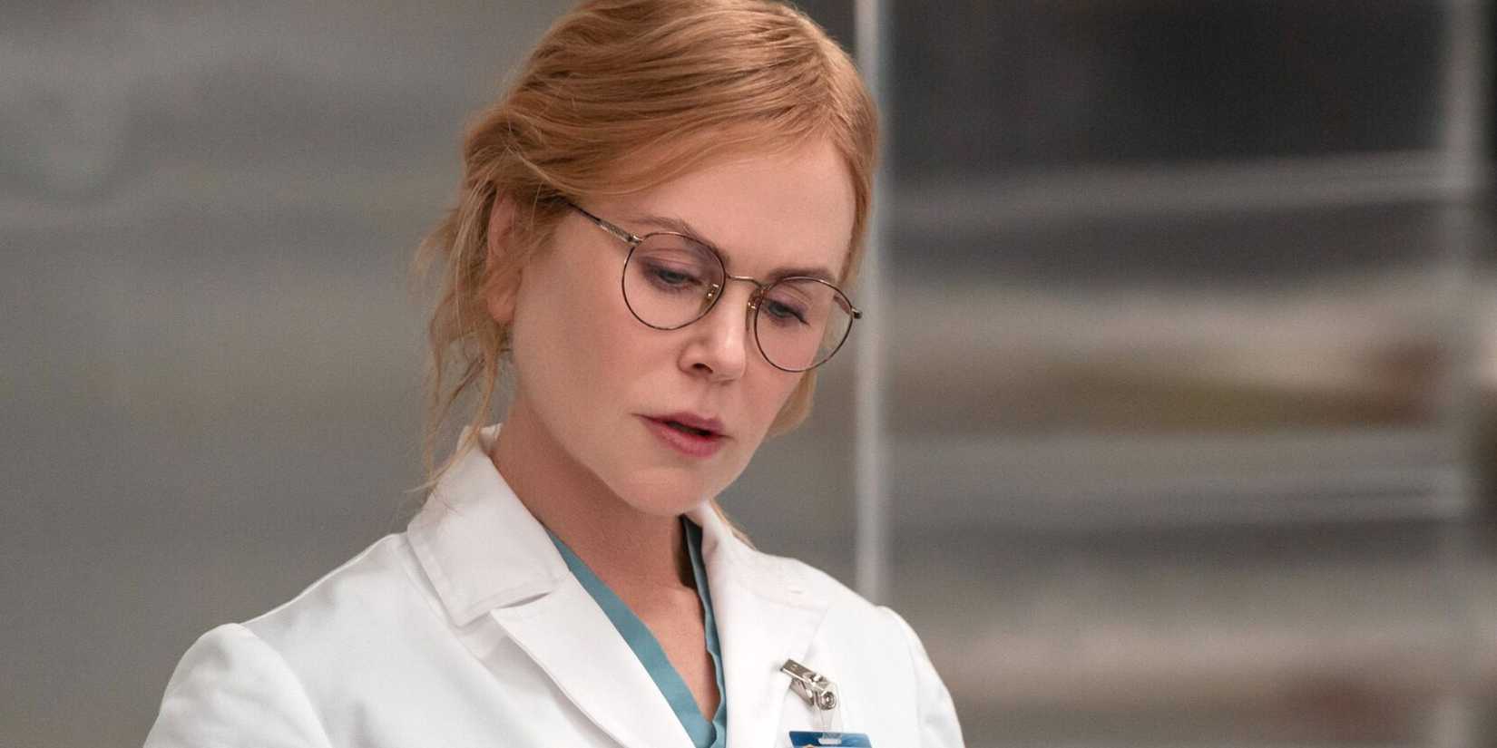 Kay Scarpetta looking down in a lab coat