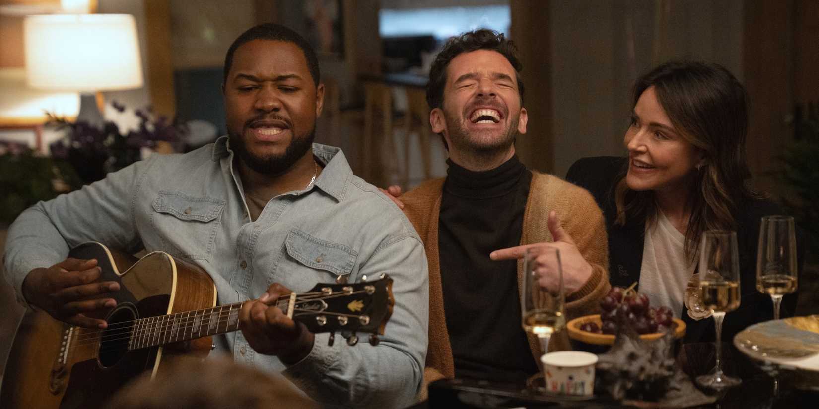 Luke Tennie as Sean playing guitar next to Michael Urie and Christa Miller in Shrinking Season 3