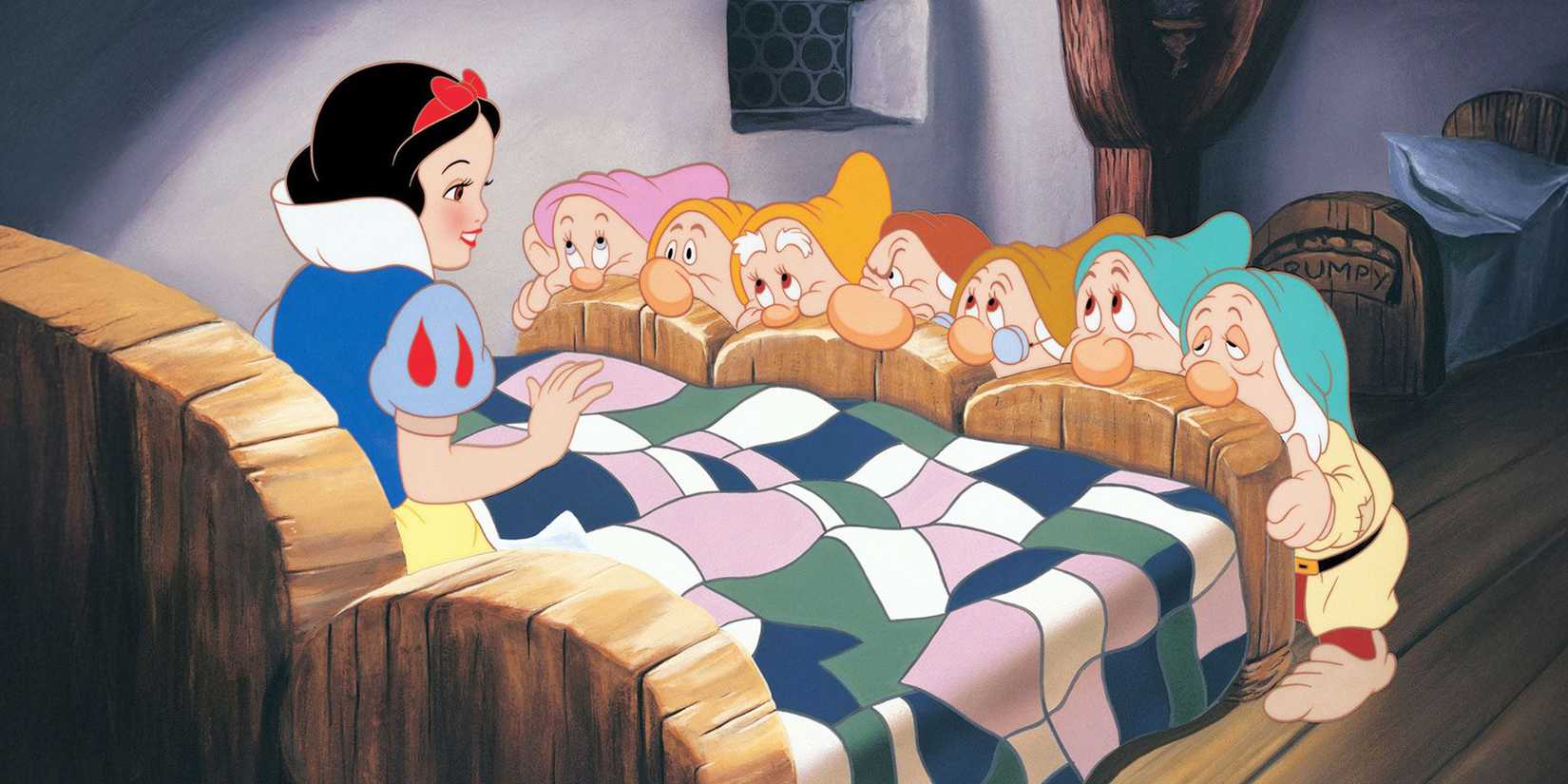 Snow White in bed with the seven dwarfs looking at her