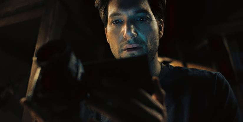 Jeff Wilbusch looking at a camera in Something Very Bad Is Going to Happen Episode 4