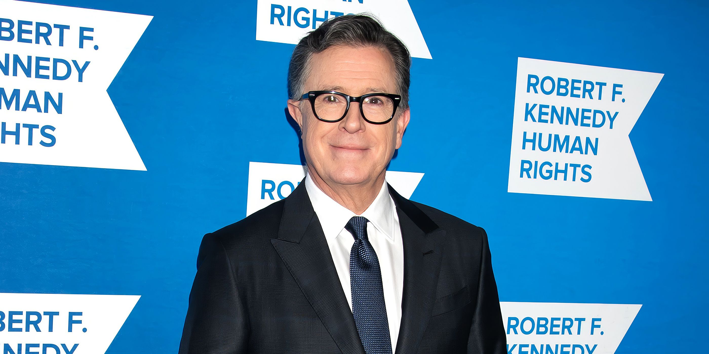 Stephe Colbert smiling on the red carpet