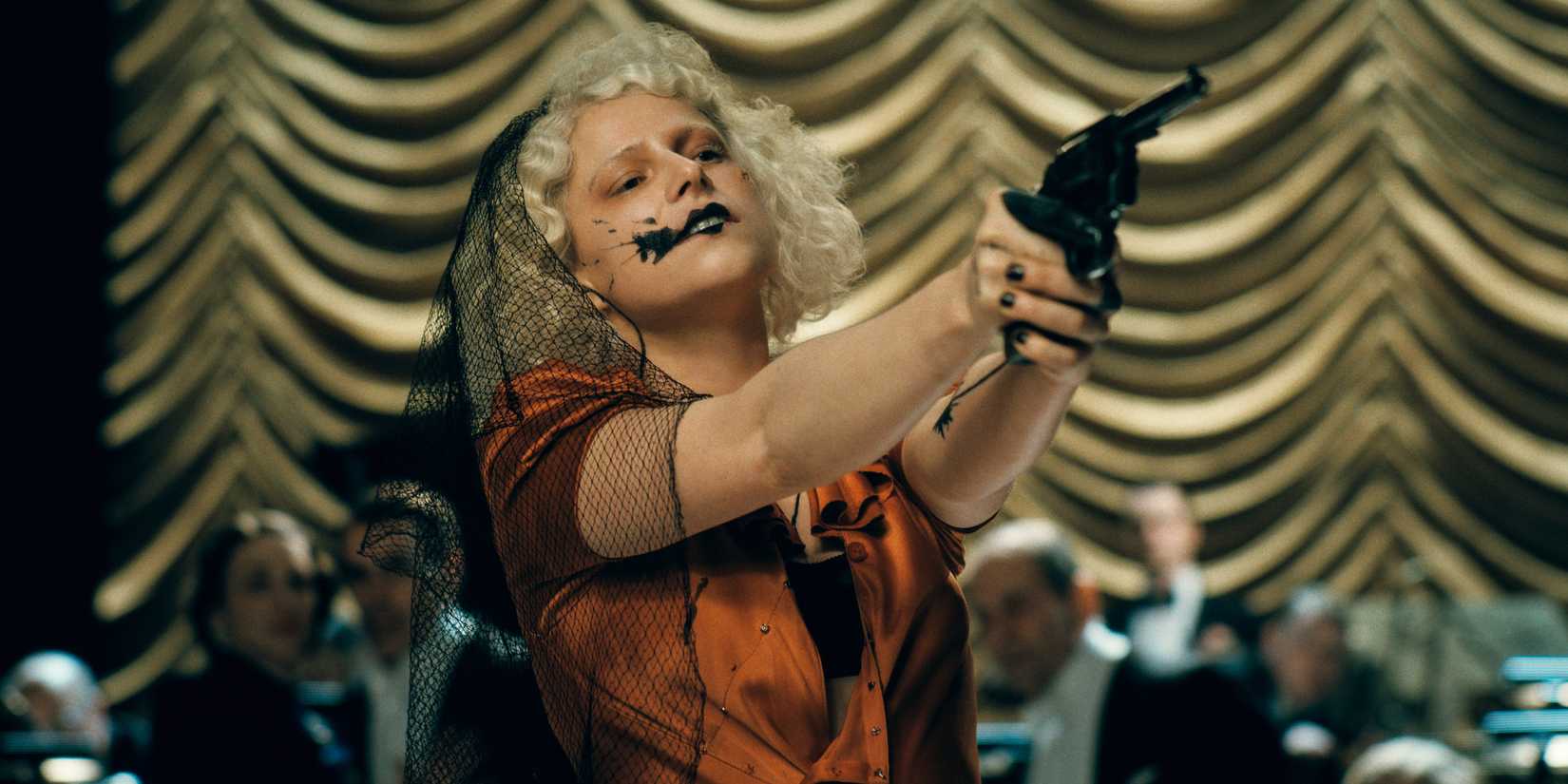 The Bride is aiming a gun. 