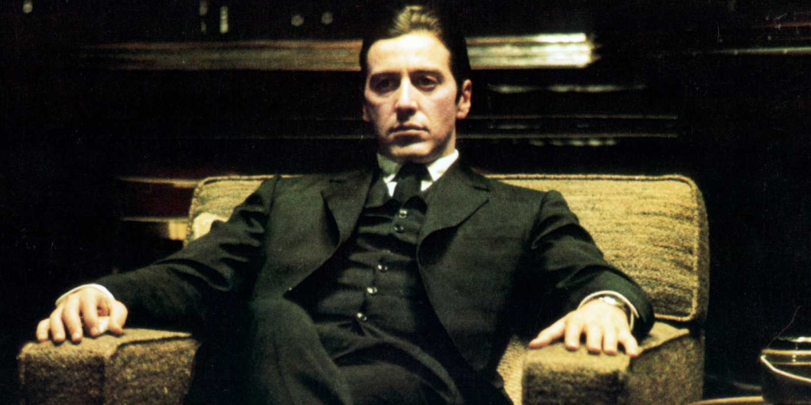 Al Pacino as Michael Corleone sitting on a chair in the darkness in The Godfather Part II (1974)