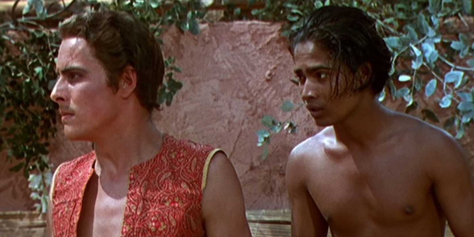 Ahmad and Abu stand in front of a wall