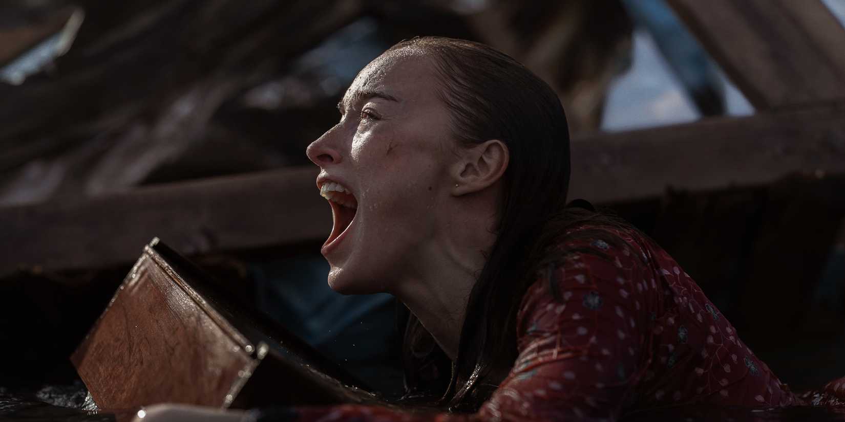 Phoebe Dynevor screaming while clinging to ruins in Thrash