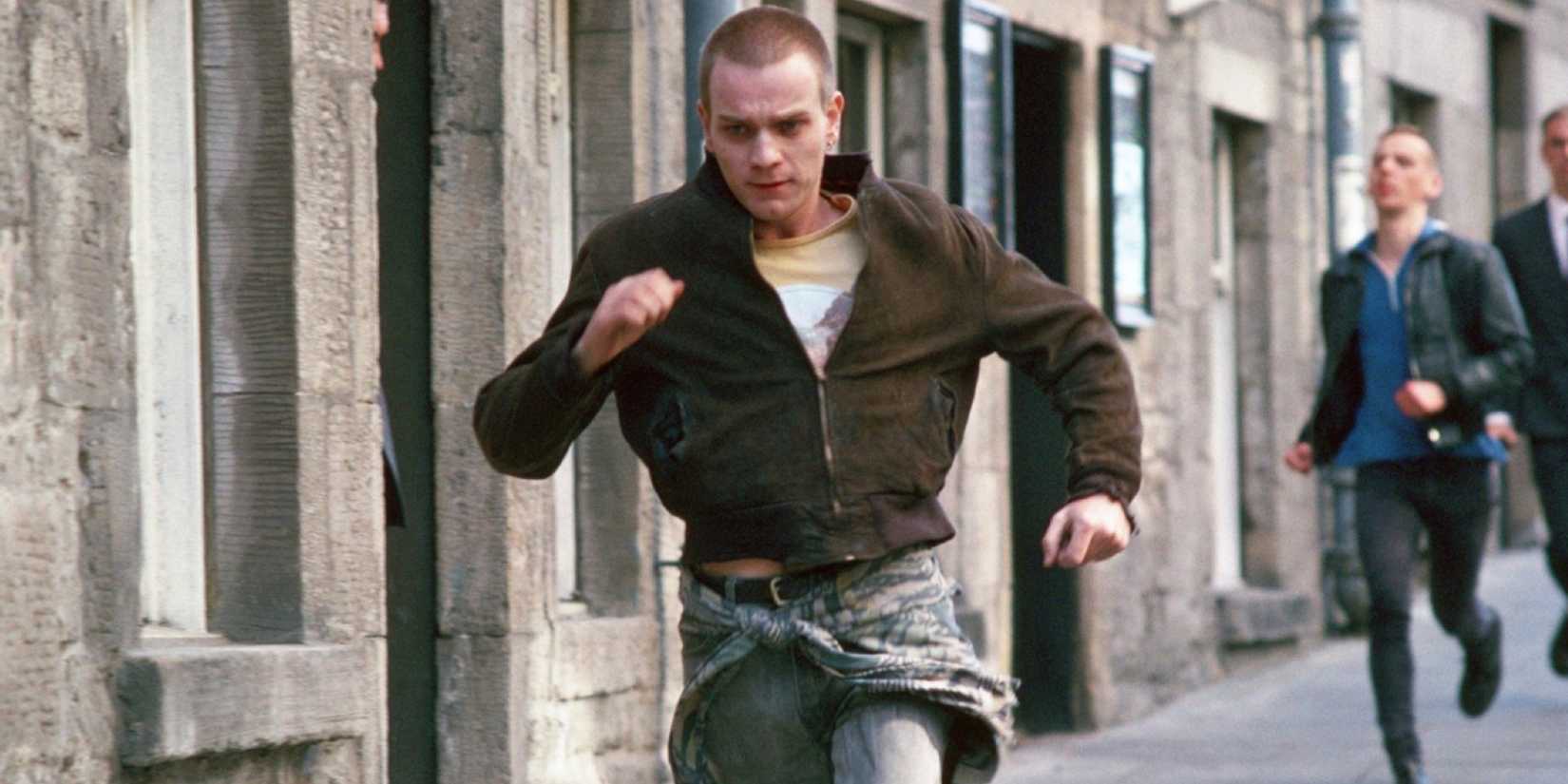 Ewan McGregor as Mark "Rent Boy" Renton running down a street in Trainspotting (1996)