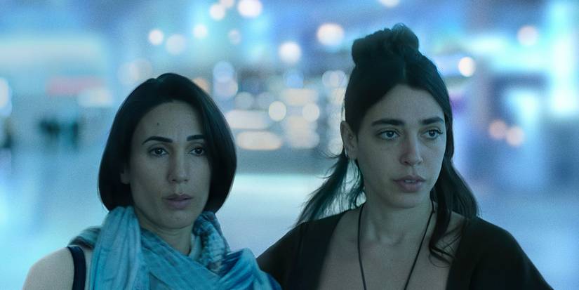 Two women standing together in Unconditional.