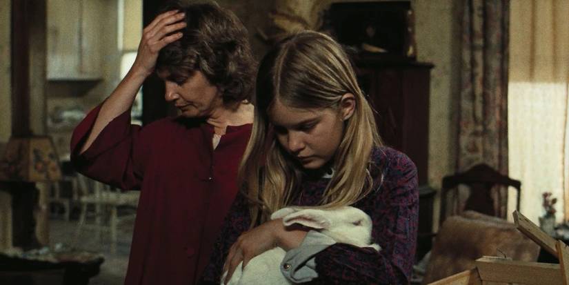 Woman with girl holding a rabbit in 'The Effect of Gamma Rays on Man-in-the-Moon Marigolds'