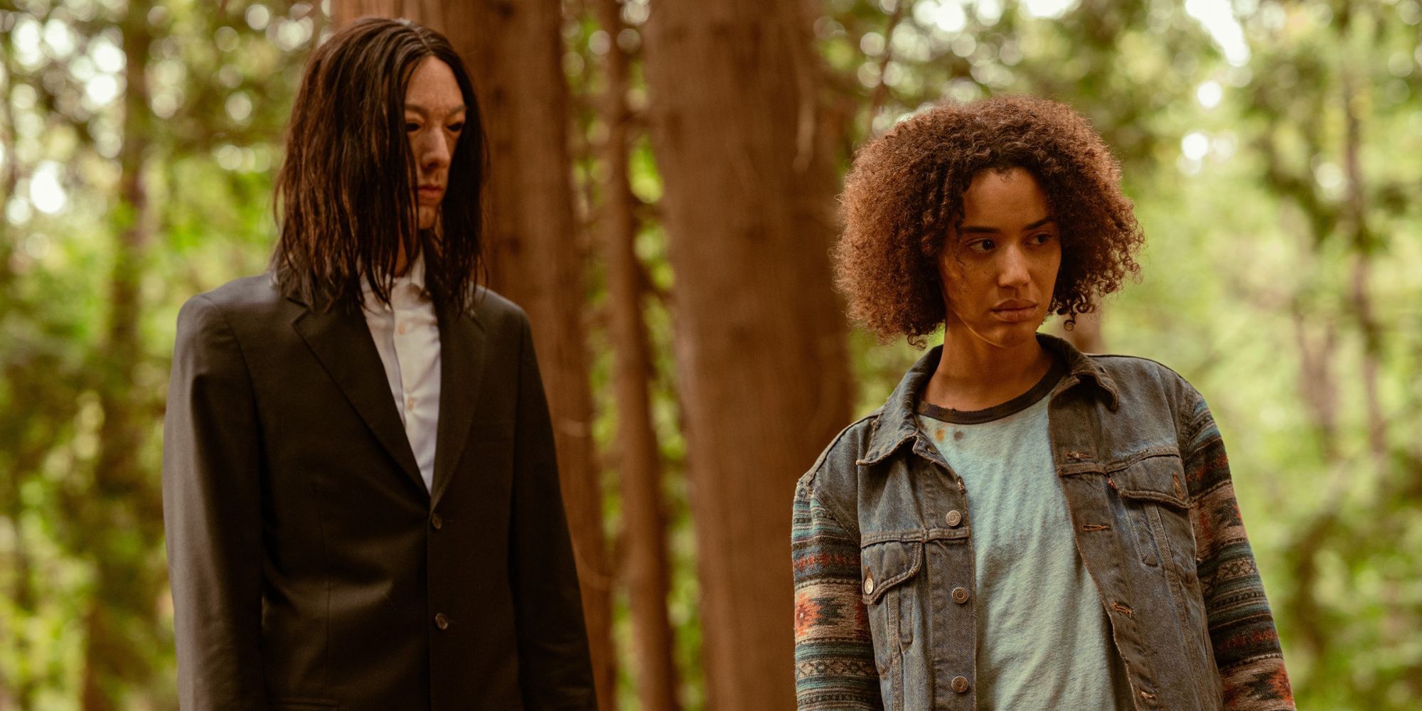 Taissa in the woods next to the Eyeless Man in Yellowjackets.