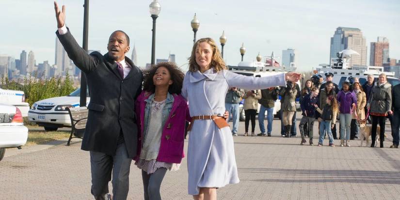 Annie strolls down with her new family in 'Annie' (2014)